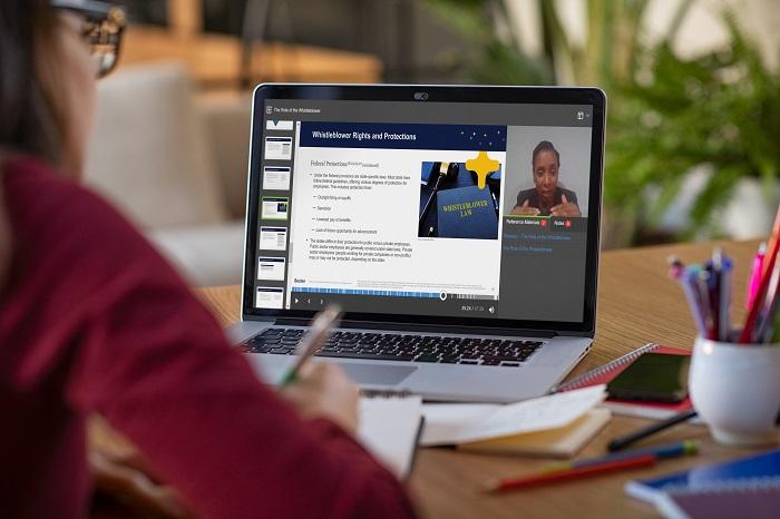 A woman looks at the Becker site while taking notes.