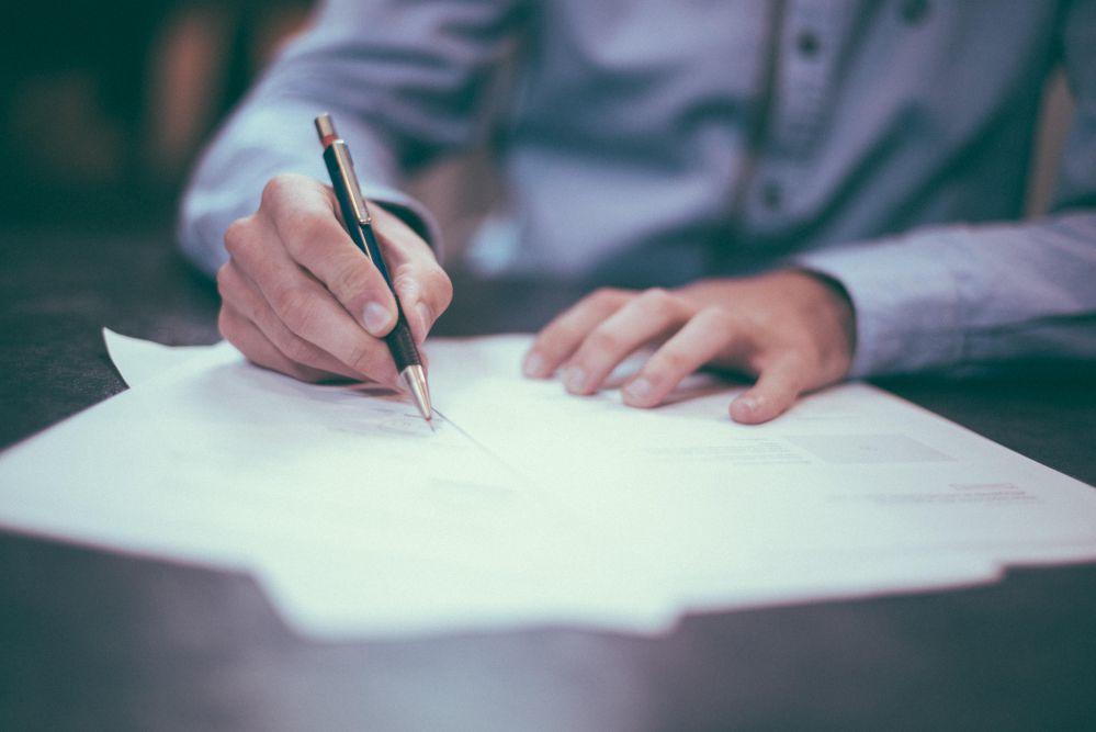 Person writing at desk