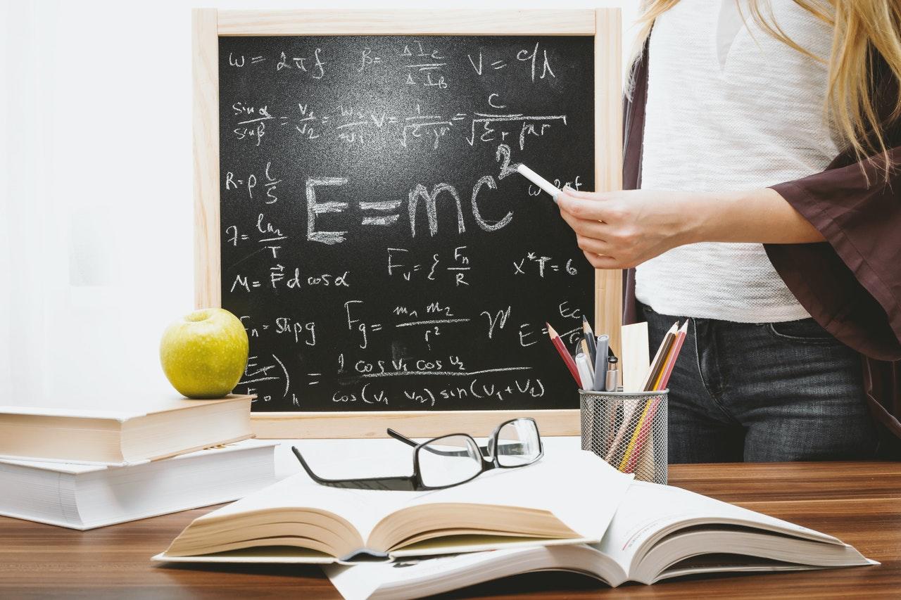 Stack of books and blackboard