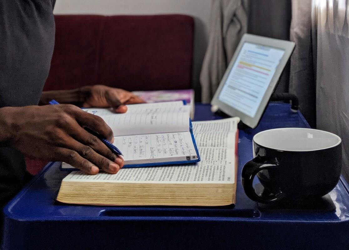 Man studying with books and tablet