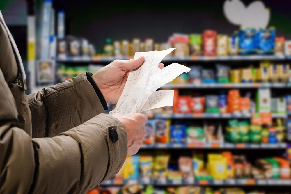 person reviewing receipts at a grocery store