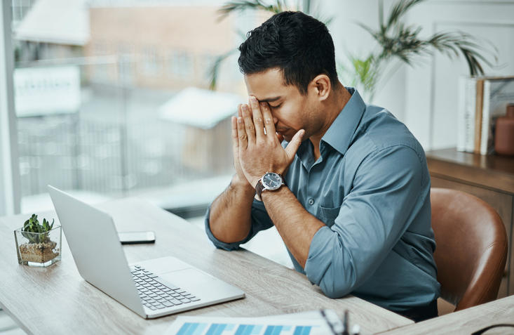 person stressed at their desk