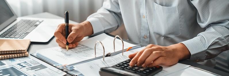 Man in button-down performing audit of unethical accounting practices