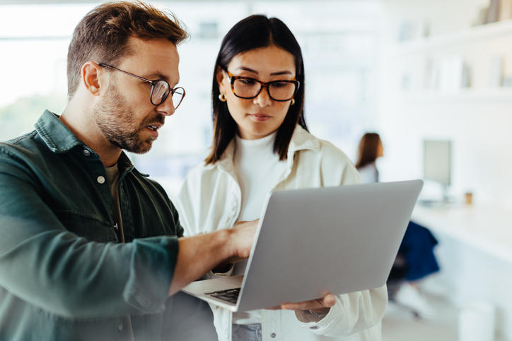 An accountant showing a co-worker findings from an IT audit